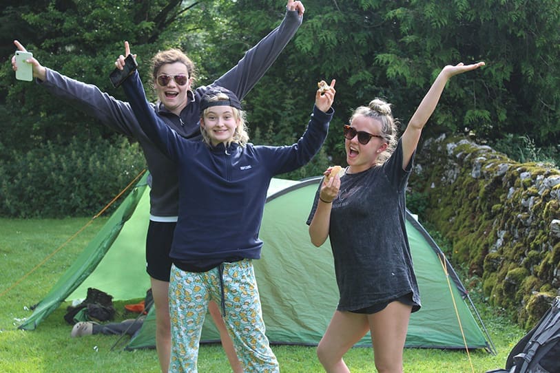 Students in front of tent on a Duke of Edinburgh expedition.